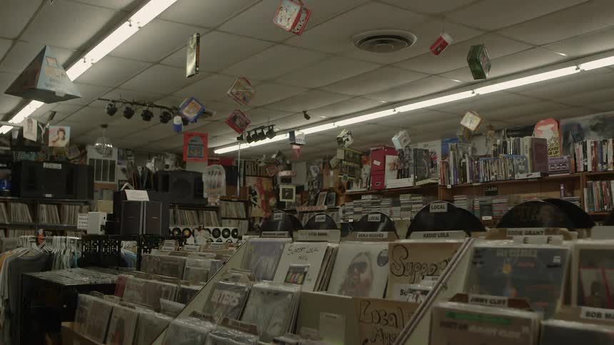 Objects hanging from the ceiling in a shop sway and turn