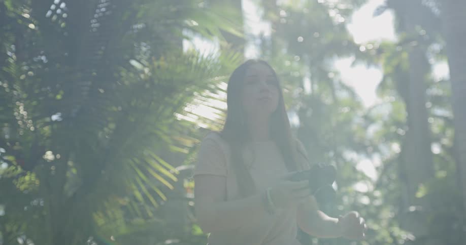A woman takes a photo in a jungle