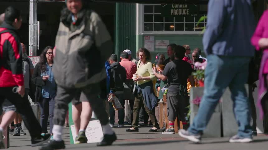 Pedestrians walk down the street