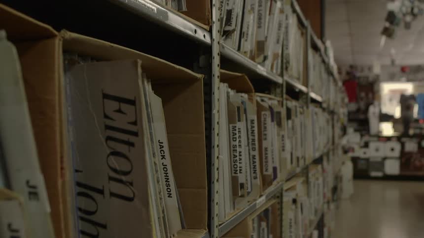 Records sit in boxes on a shelf