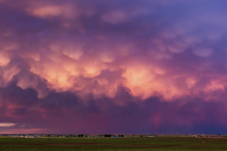 A storm is moving across a desert community at dusk