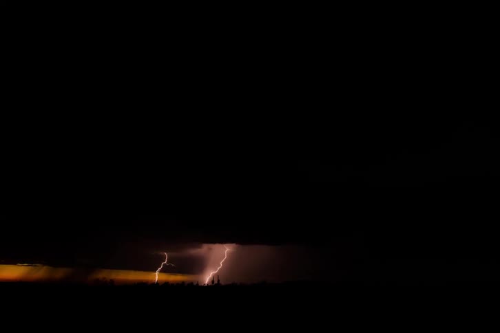 A storm brews over an open field