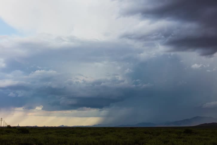 The large storm clouds move across the skyline
