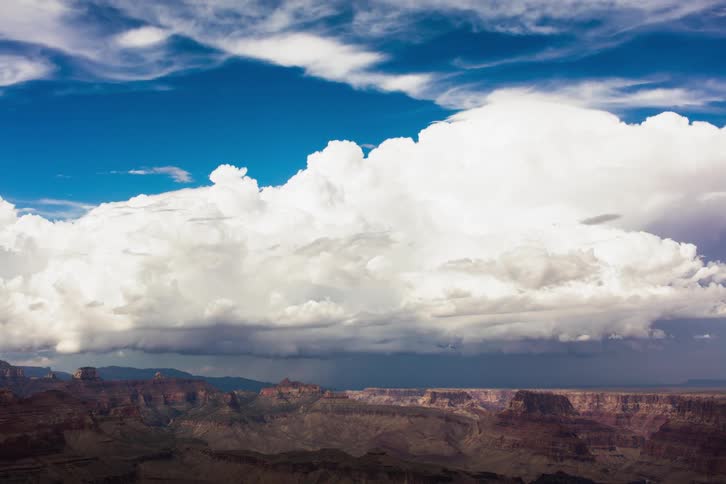 Clouds pass above a large canyon
