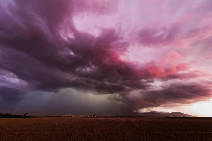 Rain and storm clouds move over fields