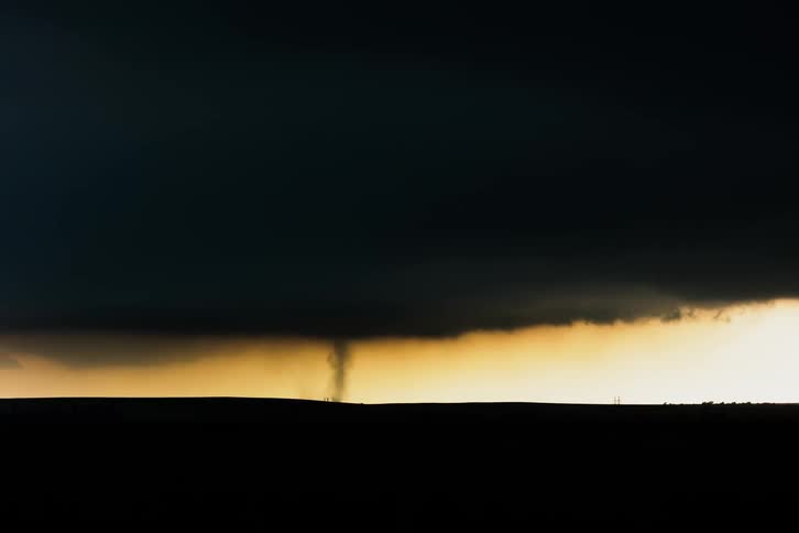 A tornado spins in a field