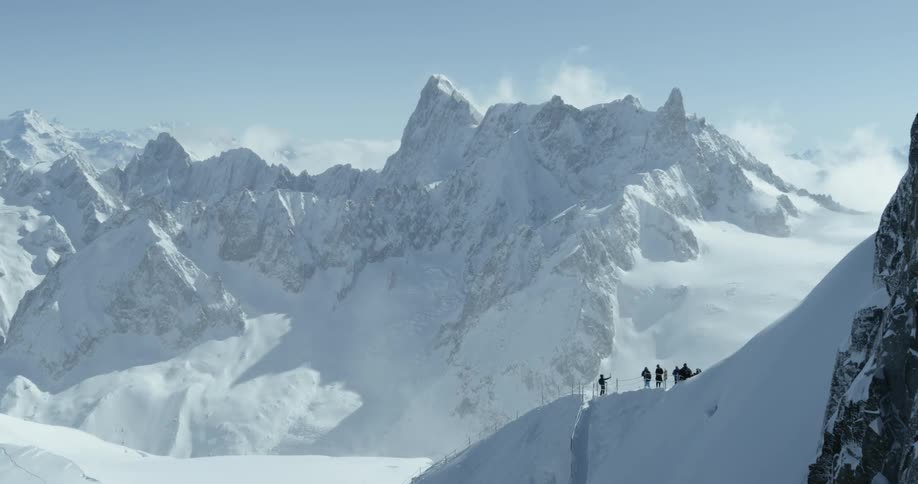 People are standing on the top of a tall mountain