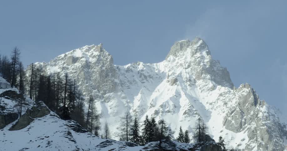 Snow covers the tall mountain