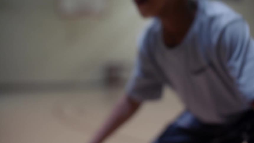 Child dribbles two basketballs one in each hand