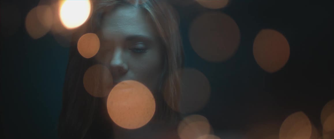 Lights flash in front of a woman's face