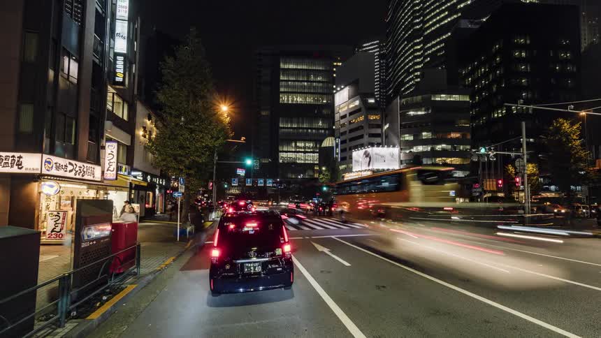 Many vehicles drive downtown at night