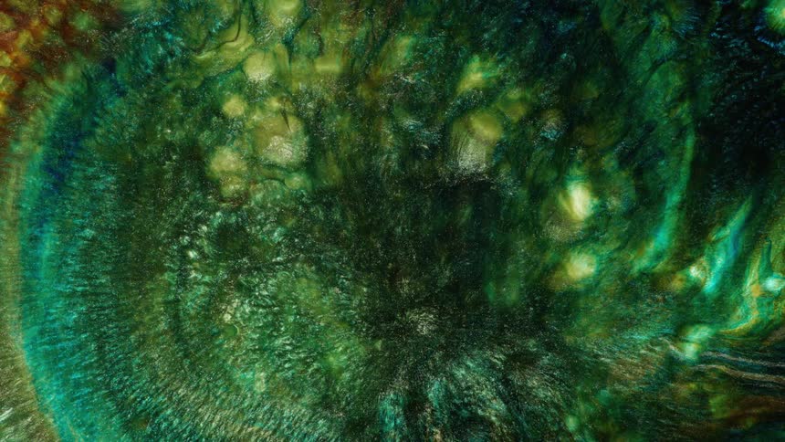 Multi-colored liquid rotates and swirls together