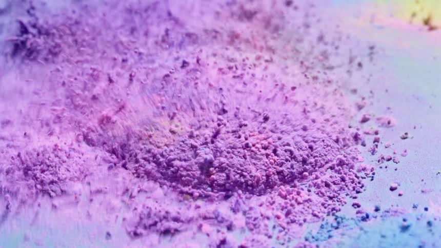 Colored granules are vibrating and bouncing on a surface