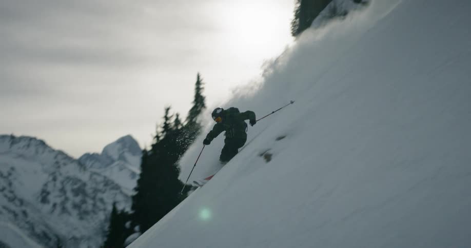 A skier descends down the slope