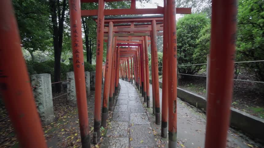 Asian style red pergolas cover a garden walkway