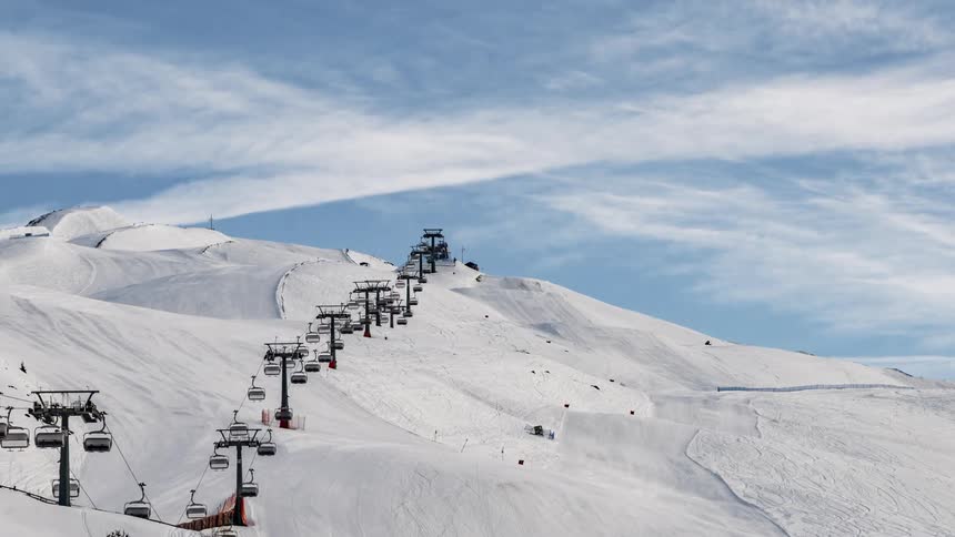 Ski lifts travel up and down the mountain
