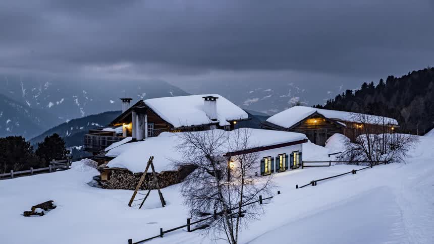 Clouds float over a snow covered chalet