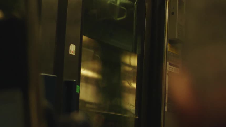 A subway train car travels at night