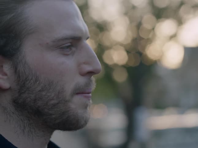 A man looks forward outside