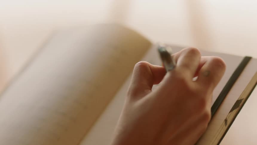 A woman writes in a journal