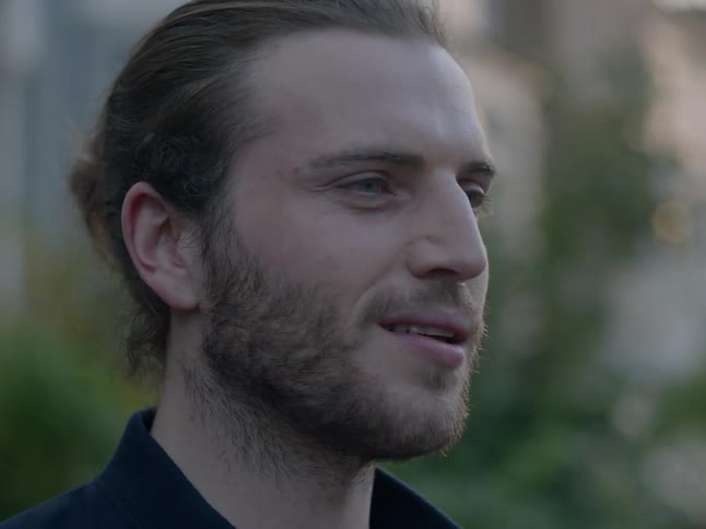 A man smiles outside