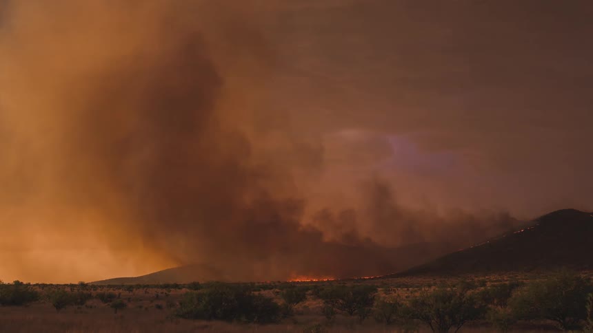 A fire burns in the desert