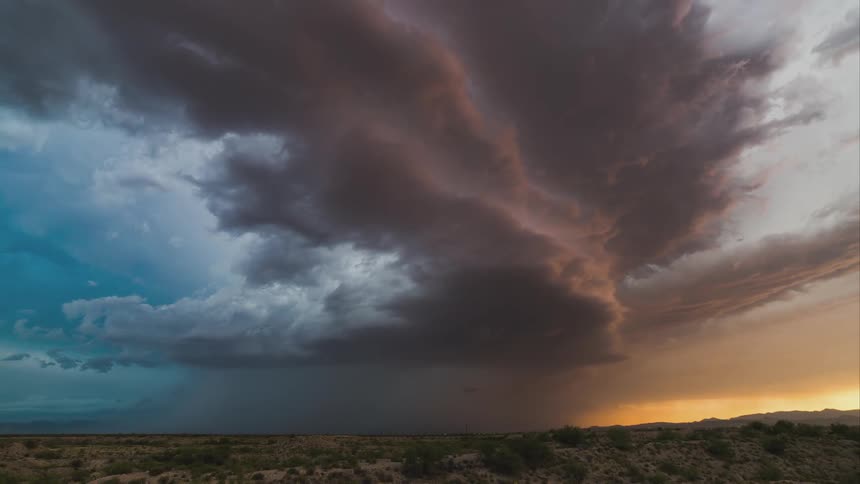 Storm clouds rolling over a field
