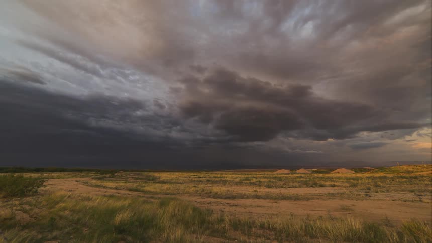 The sky darkens as storm clouds gather over flat land
