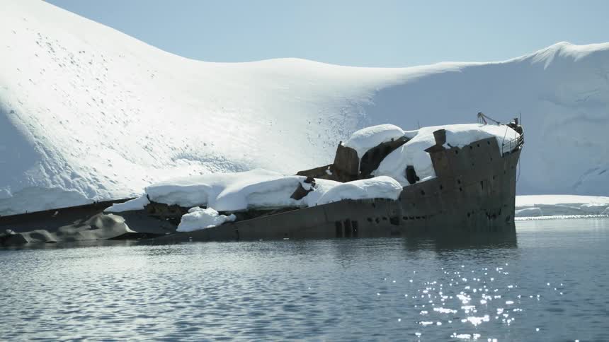Snow covers a sunken ship