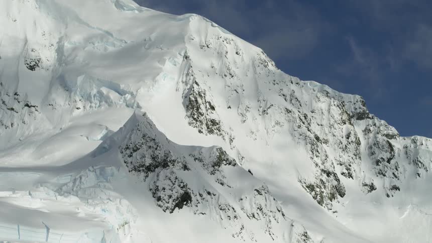 Snow covers a mountain ridge