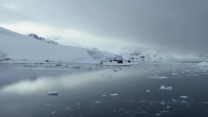 Ice chunks float on the surface near shore