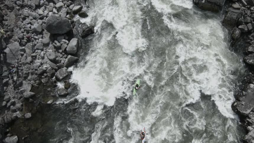 Kayaks float down a river
