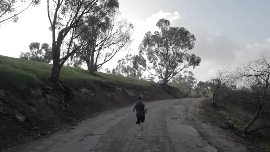 A man jogs on a rural road