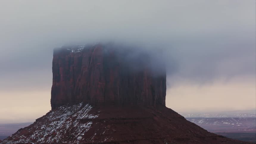 A mountain is shrouded in clouds