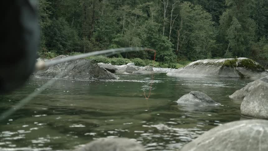 A man fishes in a stream