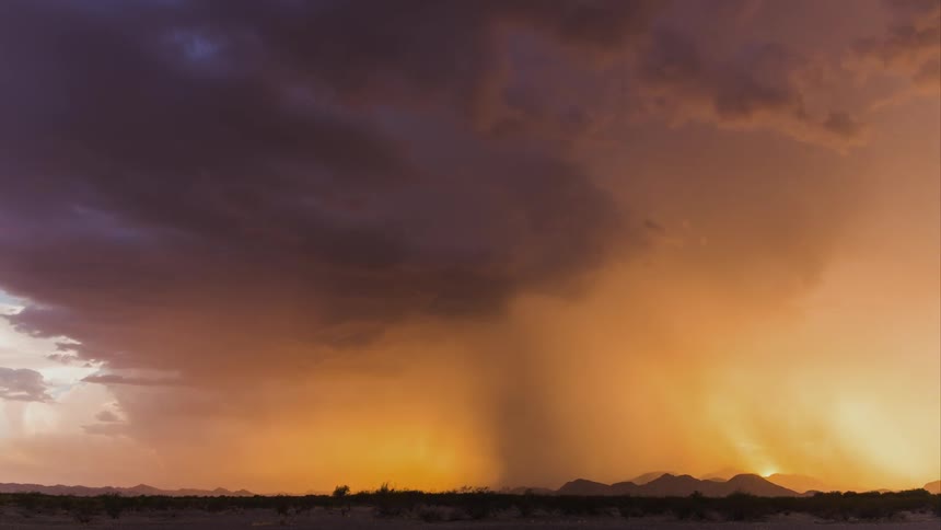 A huge storm whips up over a desert region
