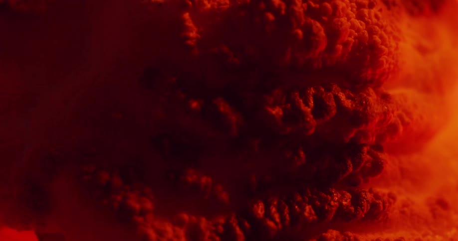 A red sandy material bubbles and expands