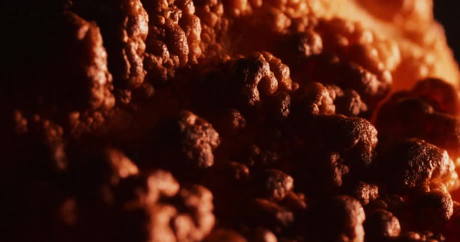 A sandy material bubbles and grows