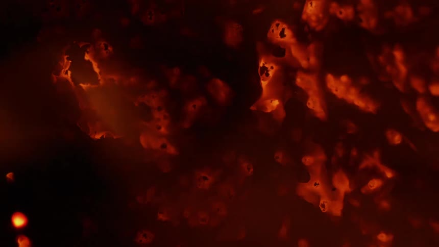 A surface glows orange as it burns