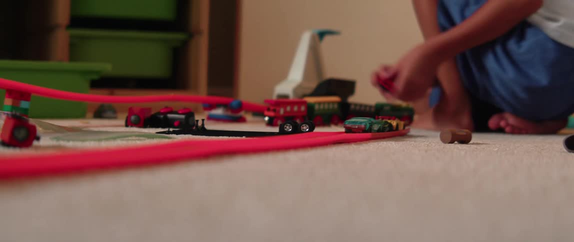 A young child plays with toy cars