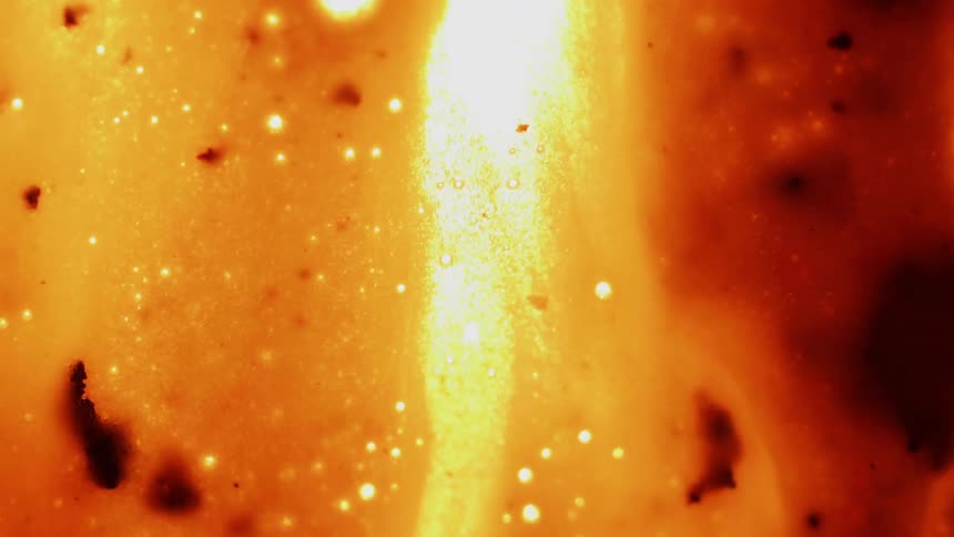 A red liquid bubbles and flows