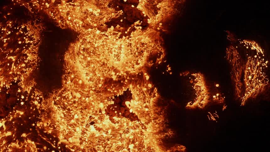 Orange embers spark and expand in heat