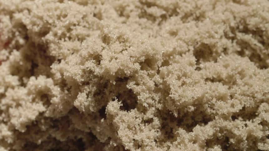 A sandy material grows and expands