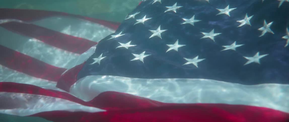 An american flag sinks underwater