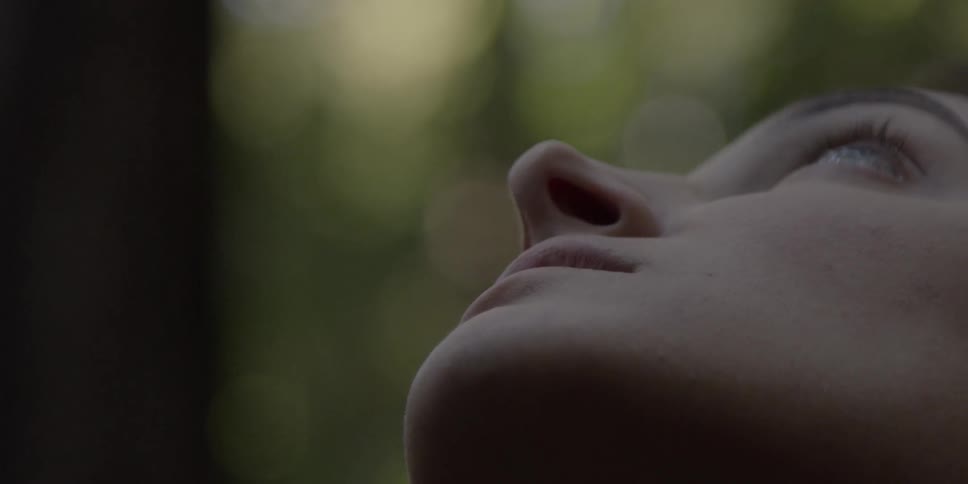 A woman looks up at the sky