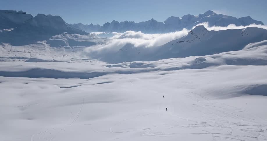 People are skiing on the long mountain range