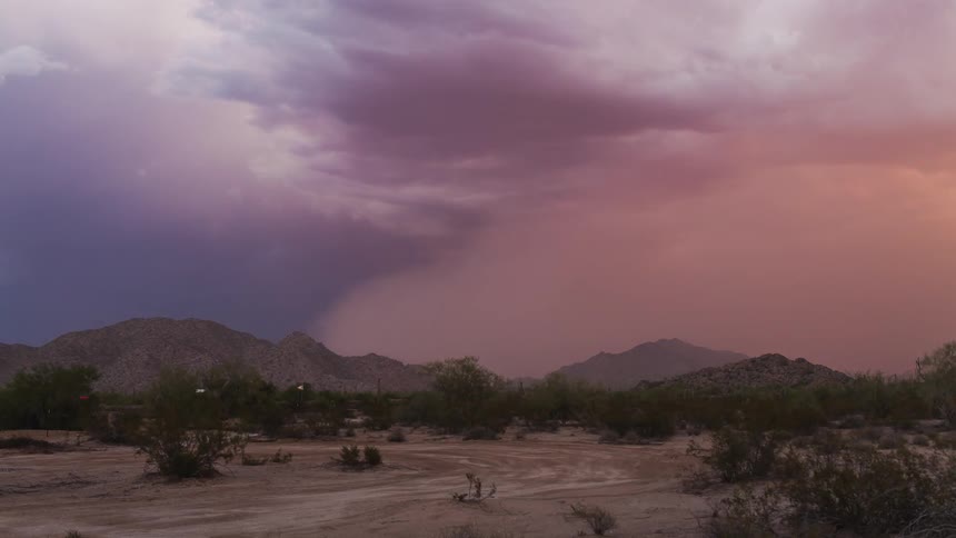 A dust storm is moving over a desert