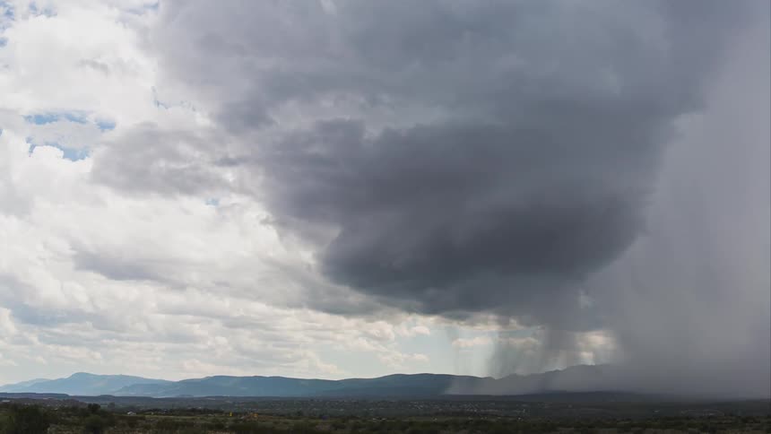 Rain and storm clouds gather as lightning flashes