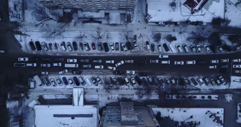 Vehicles move slowly through city traffic