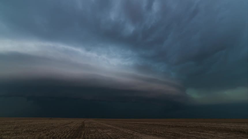 Ominous clouds float over an open field